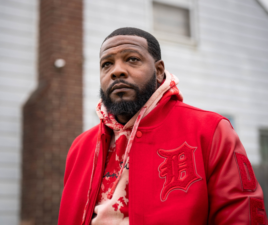 Marvin Cotton stands near the home grew up in on Meyers Road in Detroit, Michigan on November 2023